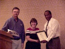 Susan Quimby, Director, IT, Motive Communications receives her recognition award from award sponsor AMD